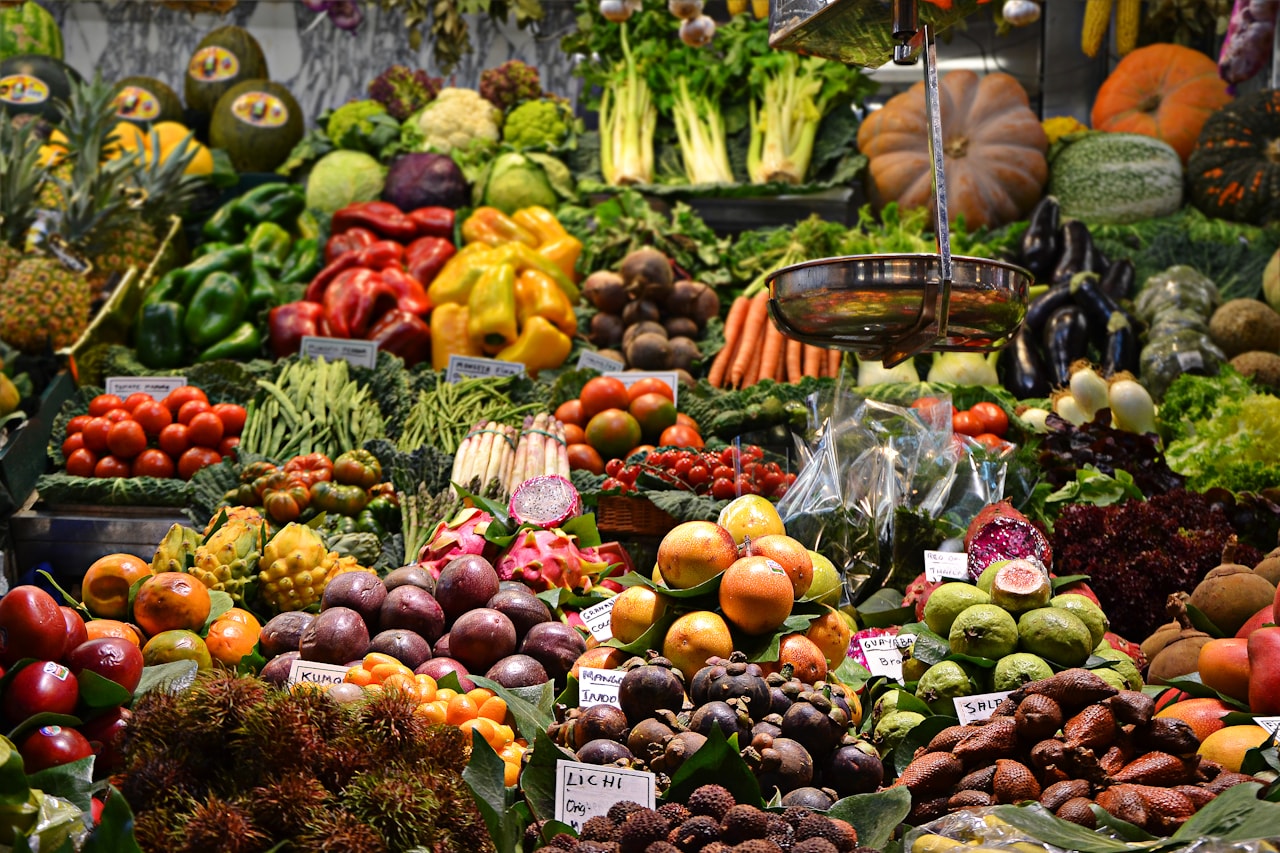 An abundant market display of fresh fruit and vegetables.